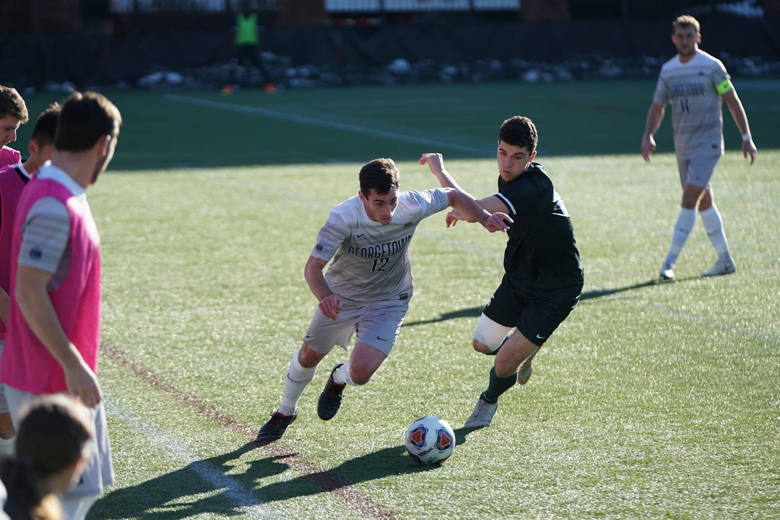 Two amateur players challenging hard for the ball mid-match